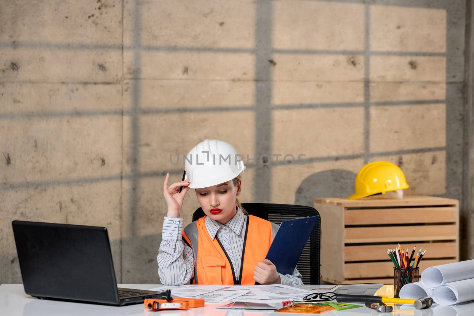 engineer in helmet and vest civil worker smart young cute blonde girl thinking