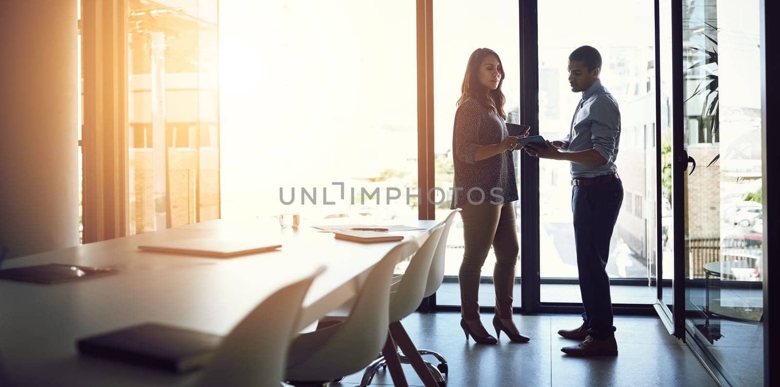 Shot of two businesspeople having a discussion in an office.