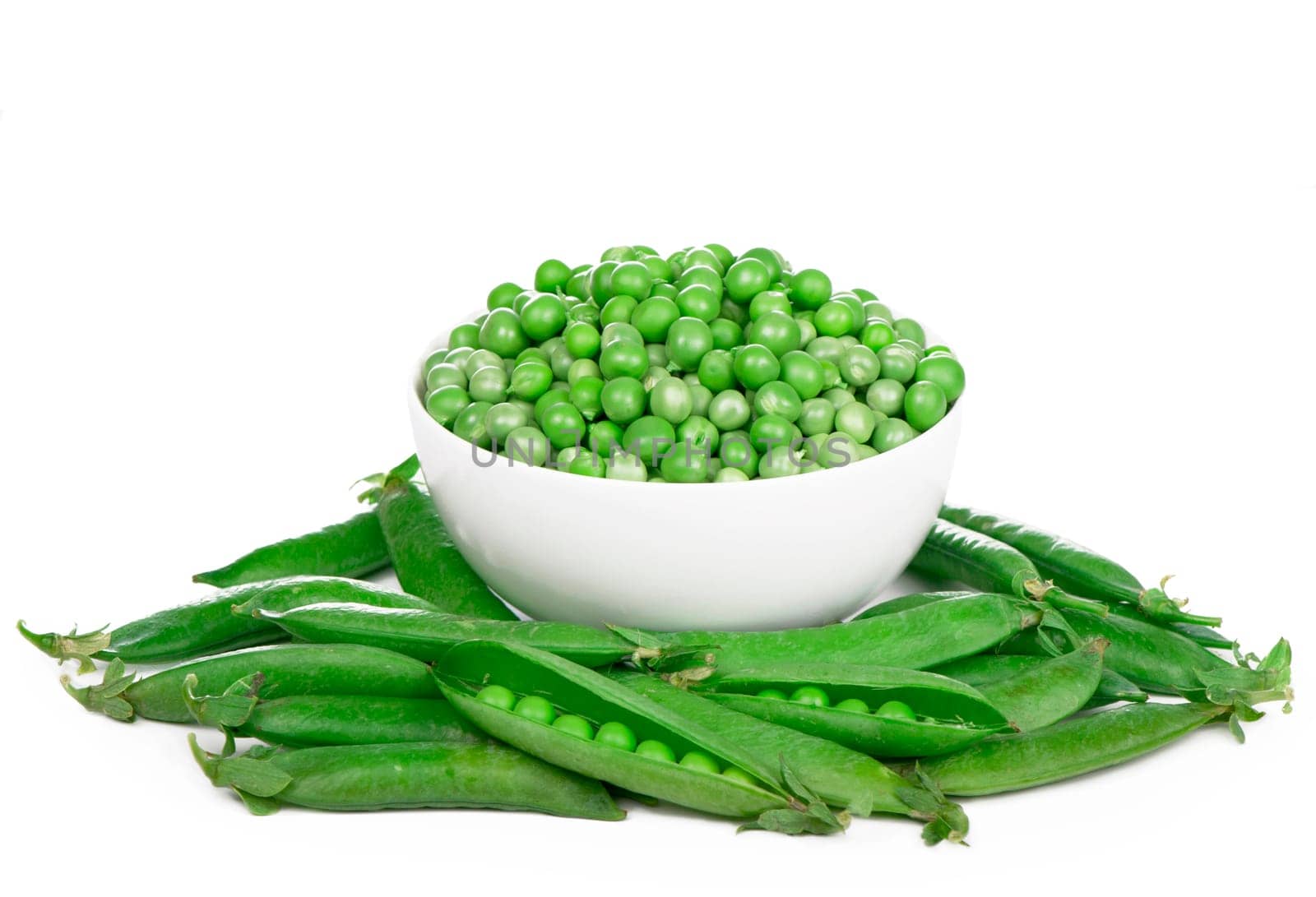 Bowl with green peas the isolated. Raw green peas in pods isolated on the white background by aprilphoto