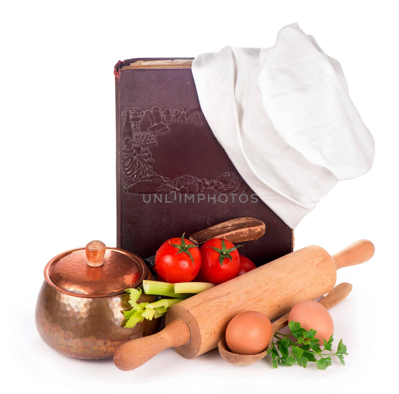 Still life with a book of ancient recipes. kitchen equipment - copper pan, rolling pin, spoons and different raw vegetables on a white background by aprilphoto