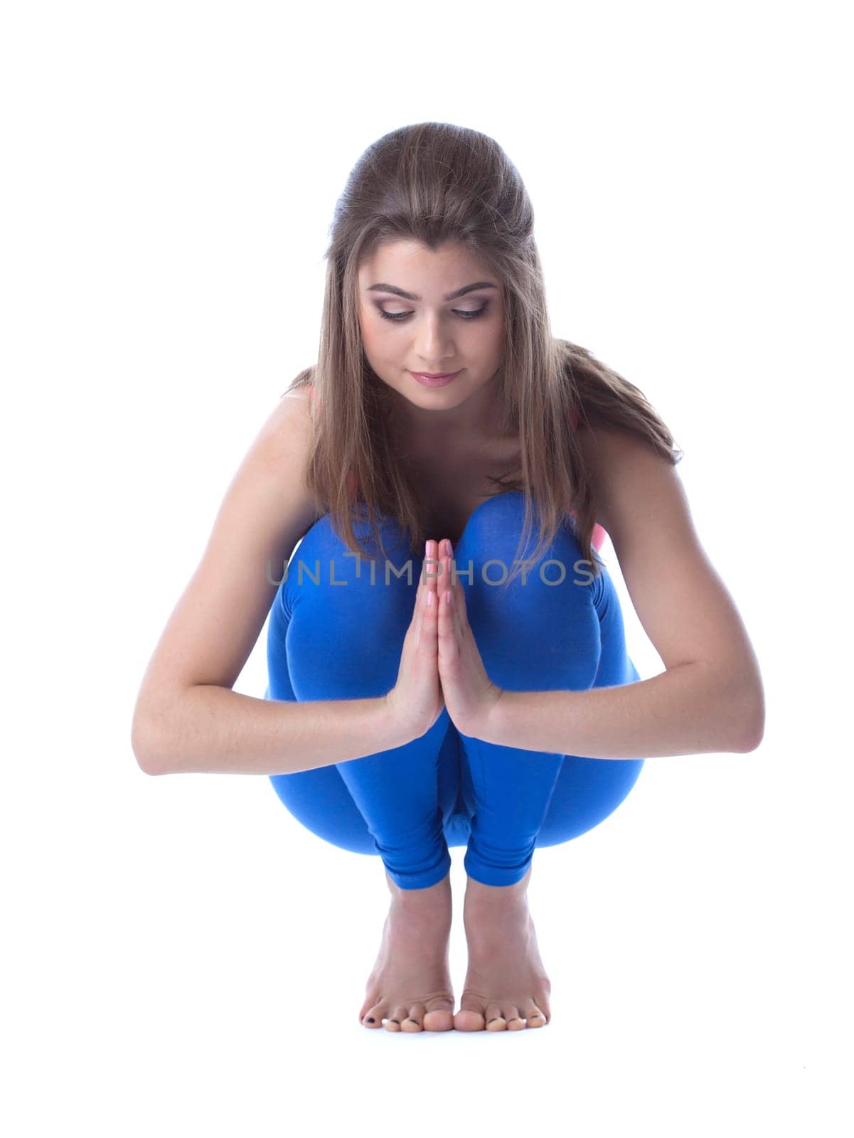 Lovely woman meditates sitting on her haunches by rivertime