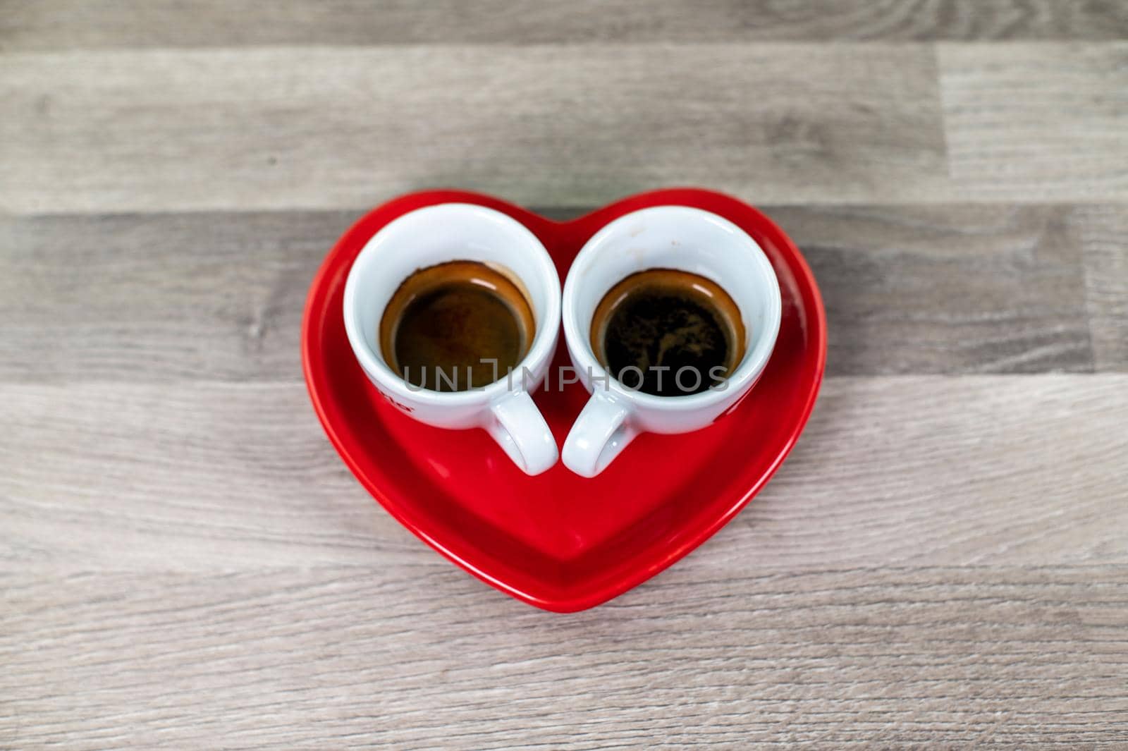 valentine heart saucer with coffee cup on wooden table