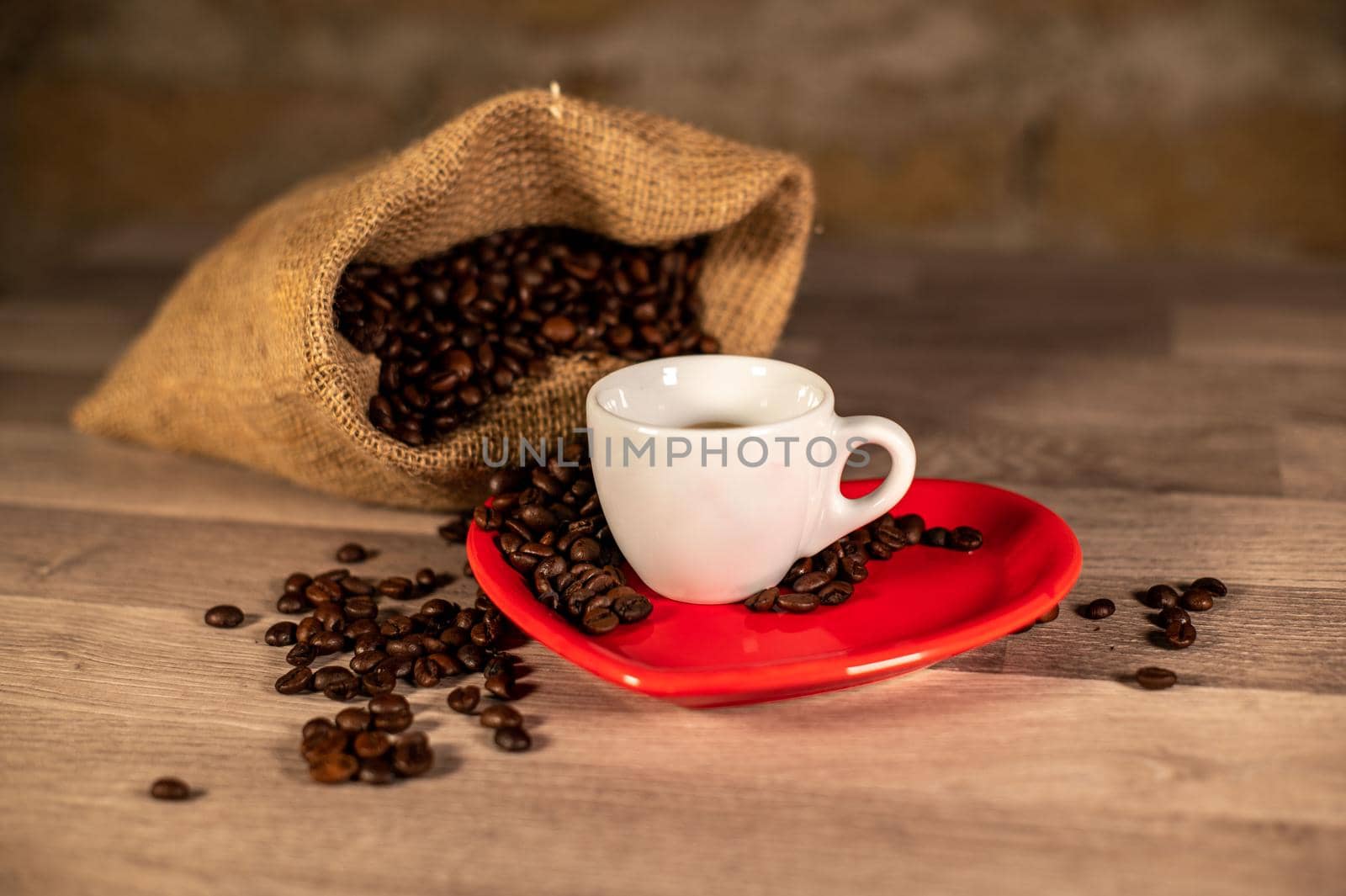 composition of coffee with grains and cups on wooden surface