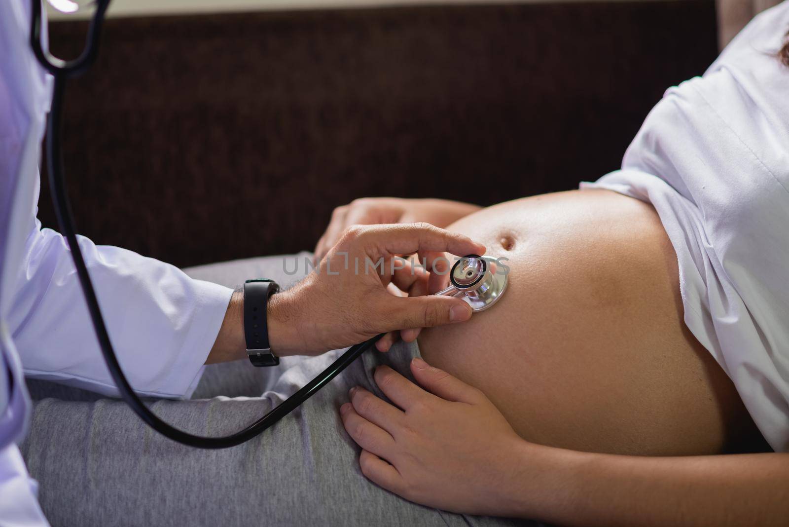 Doctor examining a pregnant woman by Wmpix