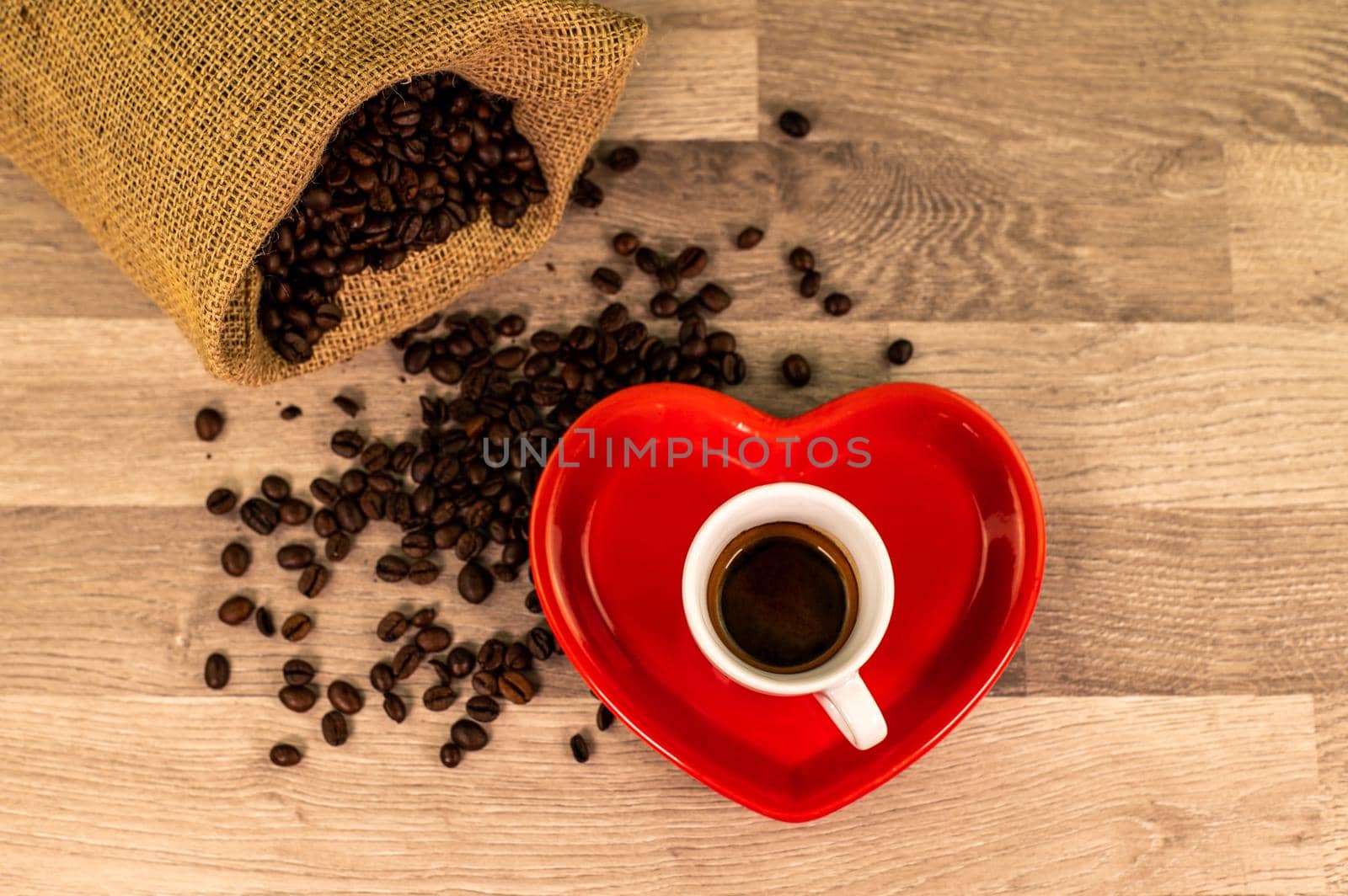 composition of coffee with grains and cups on wooden surface