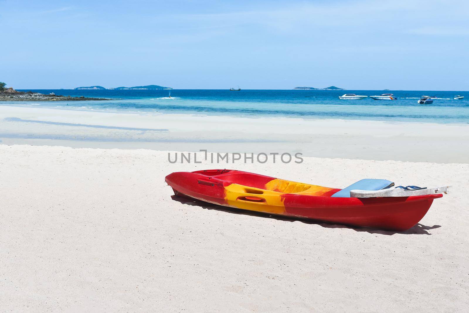 kayak boat parking on the white sand beach by Wmpix