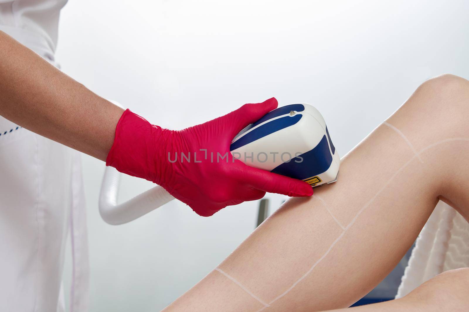 Female legs, woman in professional beauty clinic during laser hair removal