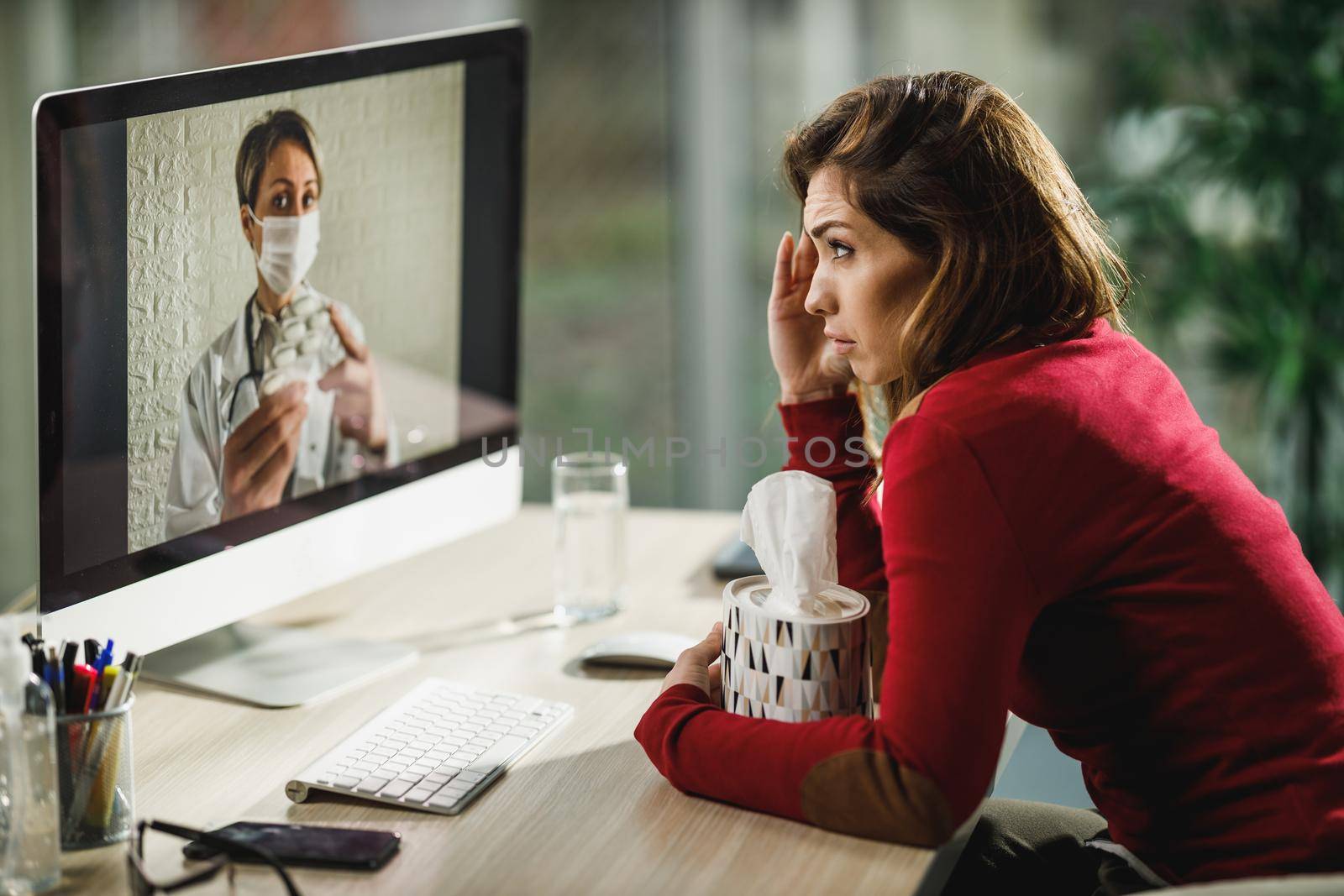 Shot of a young woman having a video call with a her doctor on a computer.