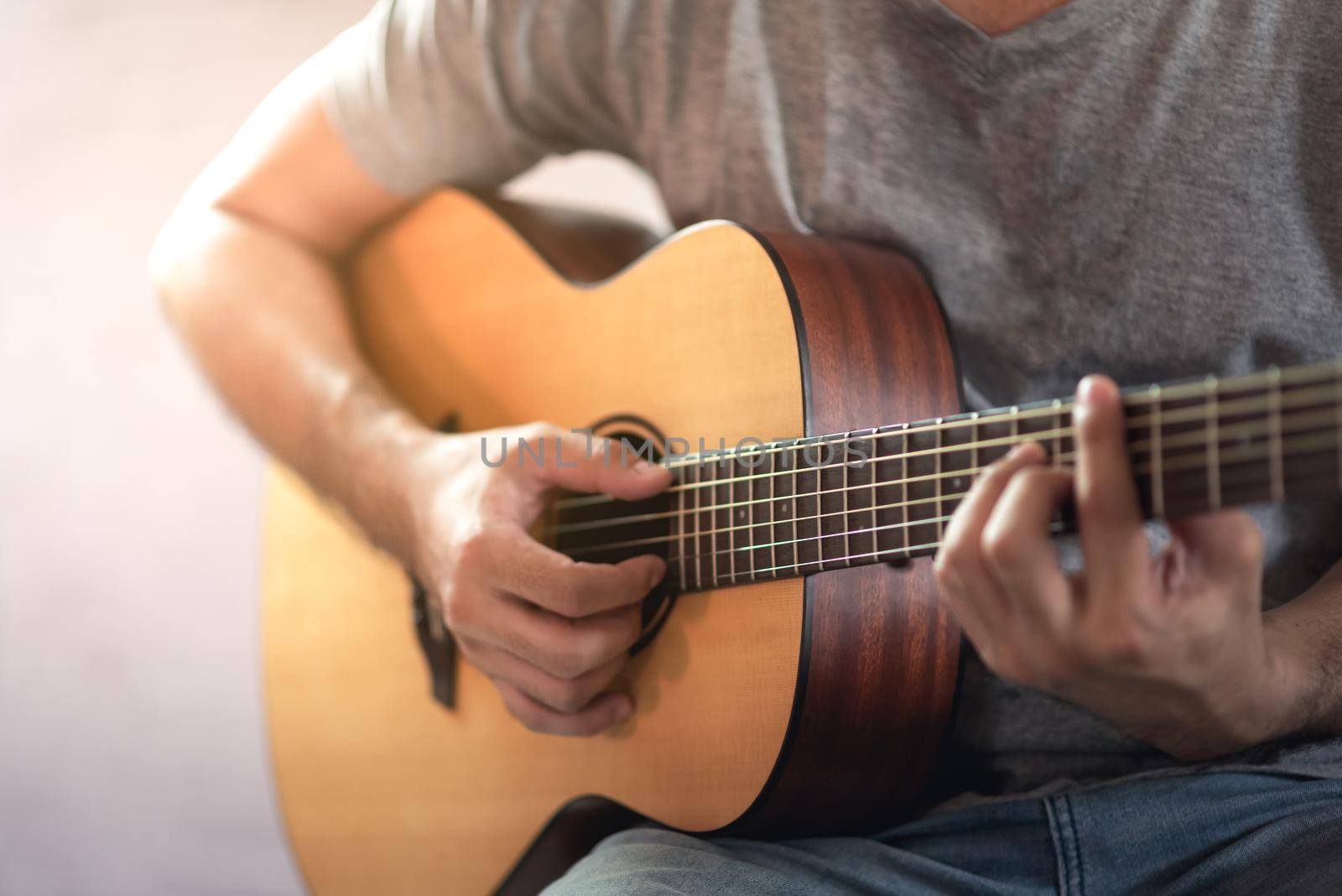 musician man playing acoustic guitar by Wmpix