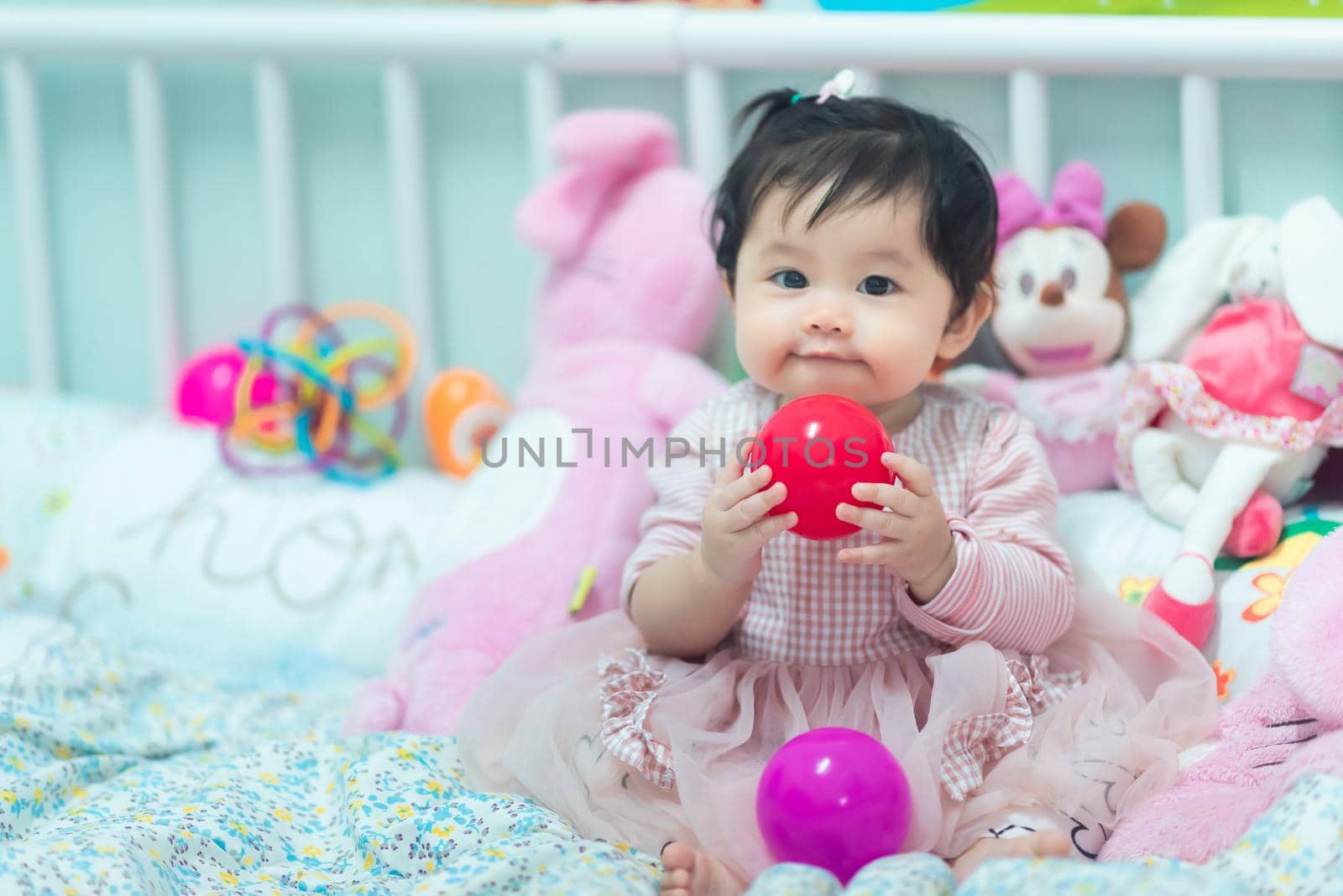 portrait of cute baby playing with ball