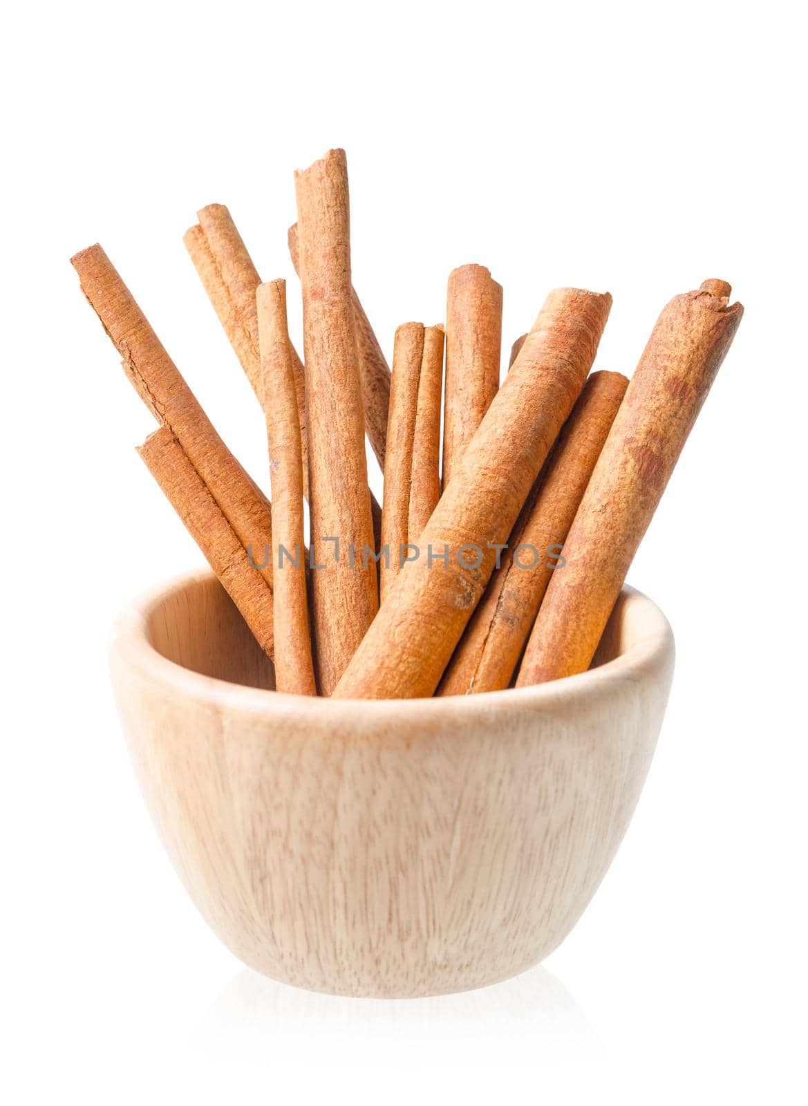 Cinnamon sticks in wooden bowl isolated on white background. by Gamjai