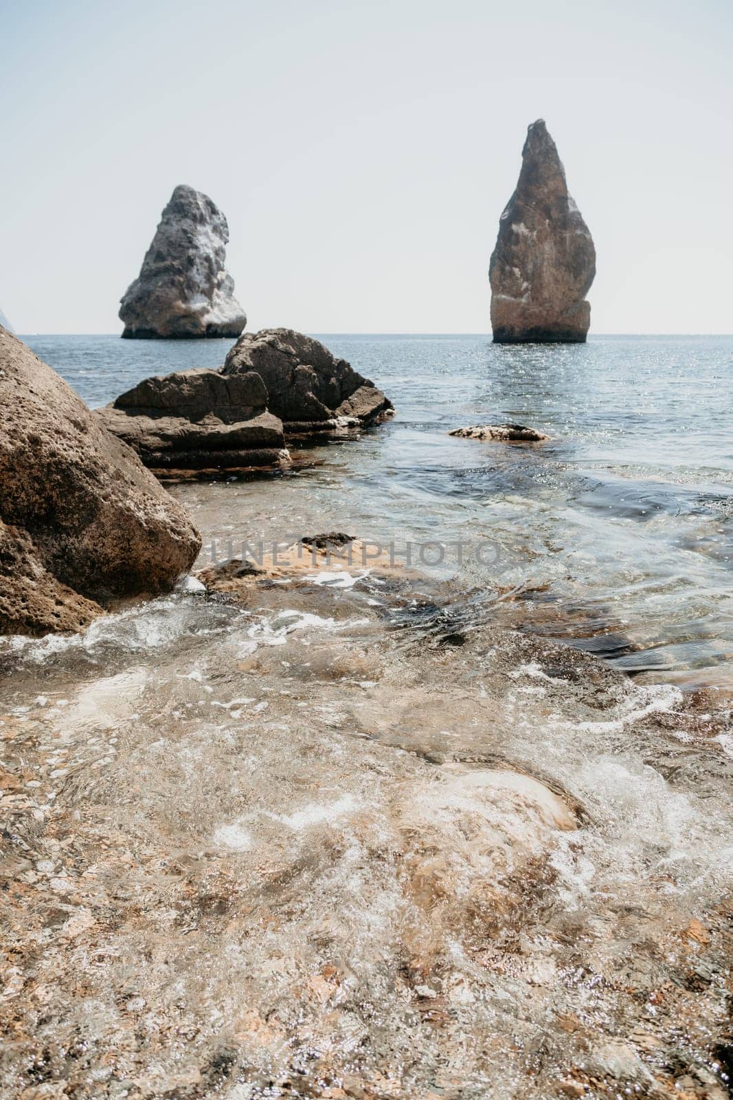 Aerial view from above on calm azure sea and volcanic rocky shores. Small waves on water surface in motion blur. Nature summer ocean sea beach background. Nobody. Holiday, vacation and travel concept by panophotograph