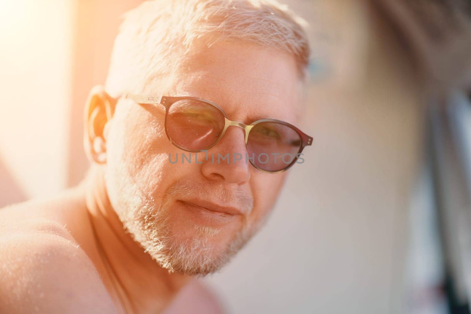 Outdoor portrait of mid aged happy caucasian man in sunglasses l by panophotograph