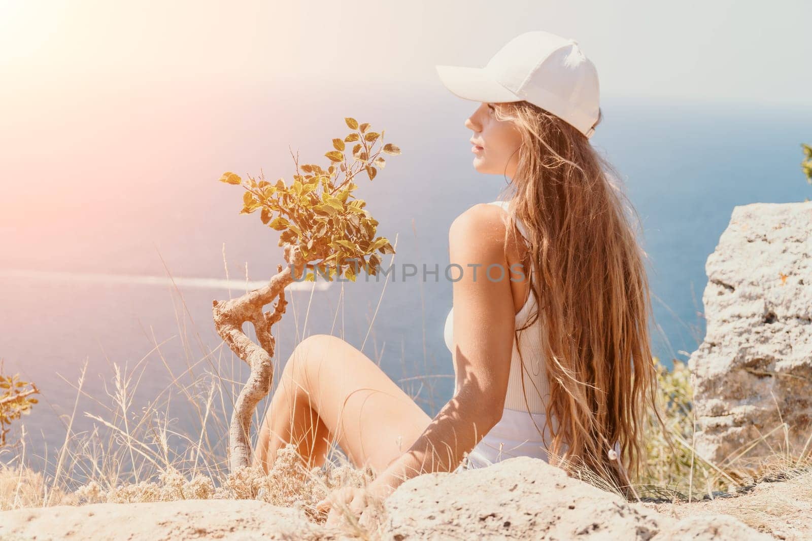 Woman summer travel sea. Happy tourist enjoy taking picture outdoors for memories. Woman traveler posing over sea bay surrounded by volcanic mountains, sharing travel adventure journey by panophotograph