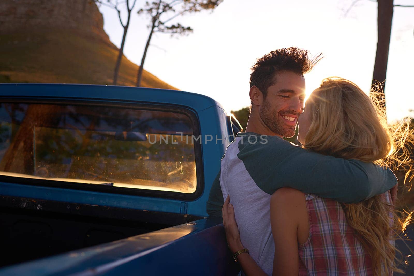 Hugging, car or happy couple on road trip in nature on romantic, holiday or vacation for bonding on date. Truck, travel or people hug or embrace on summer weekend trip with romance in park together.