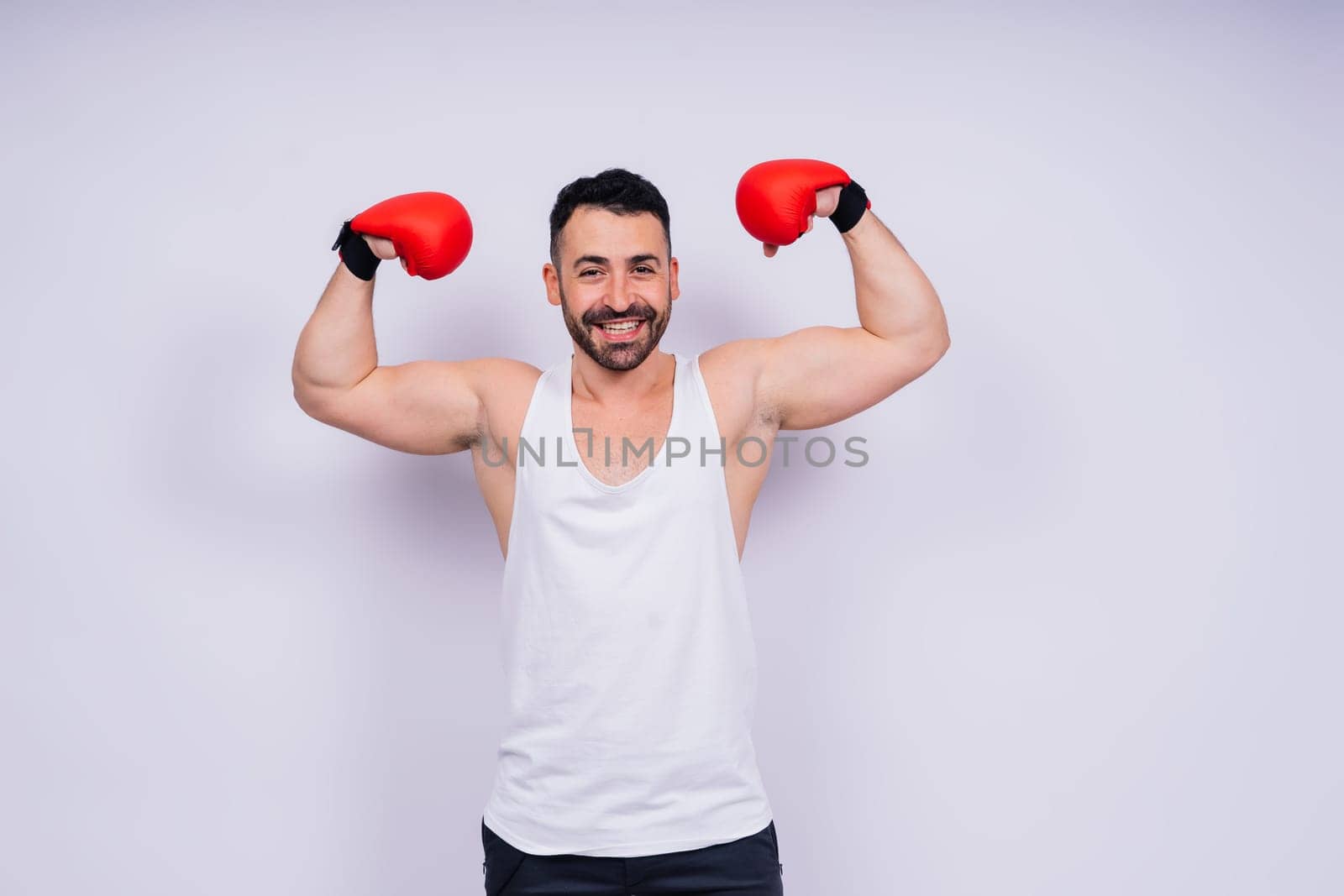 Man boxer in red sport boxing gloves at a studio, copy space.