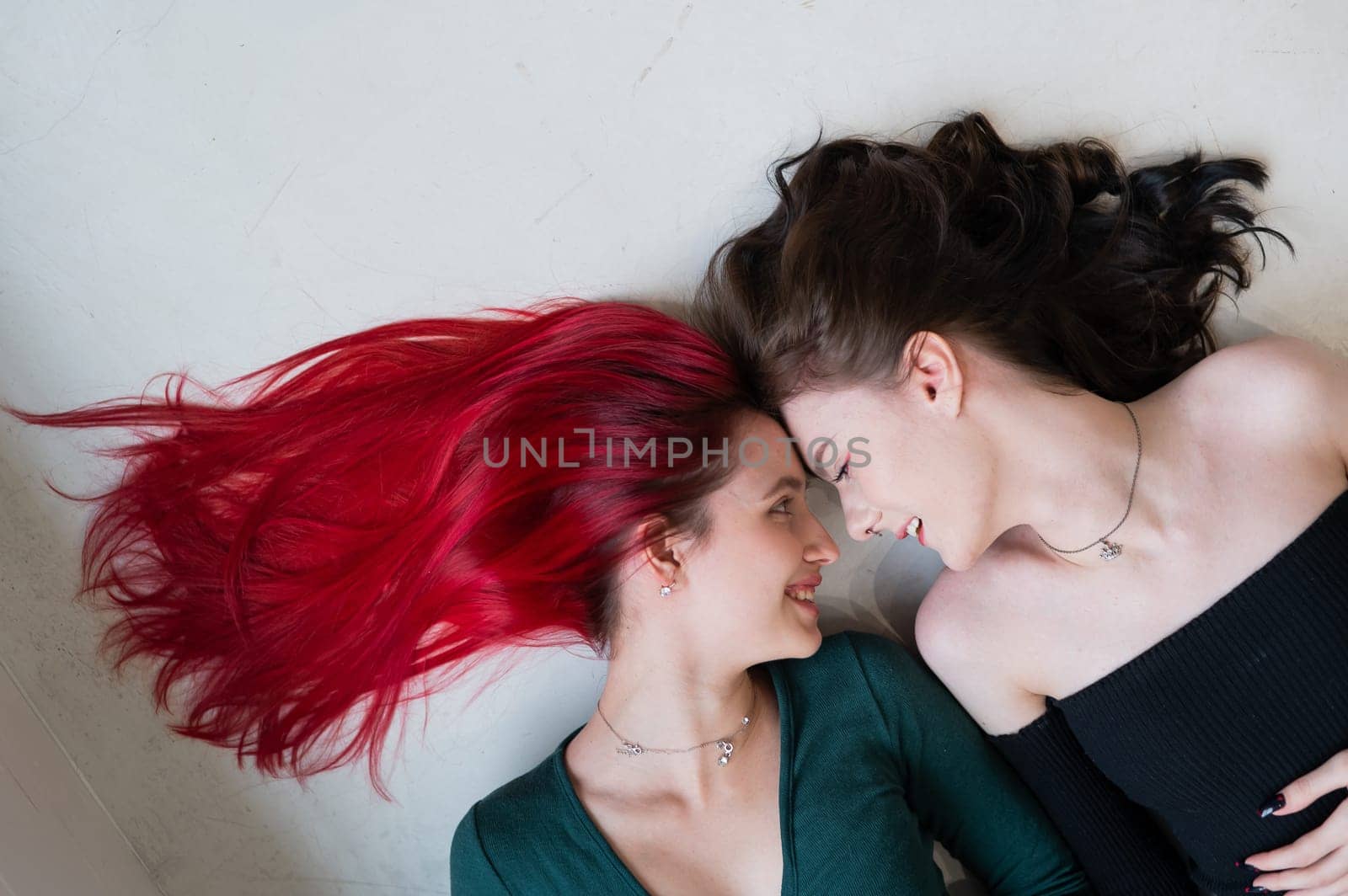 Top view of two women lying side by side. Lesbian intimacy