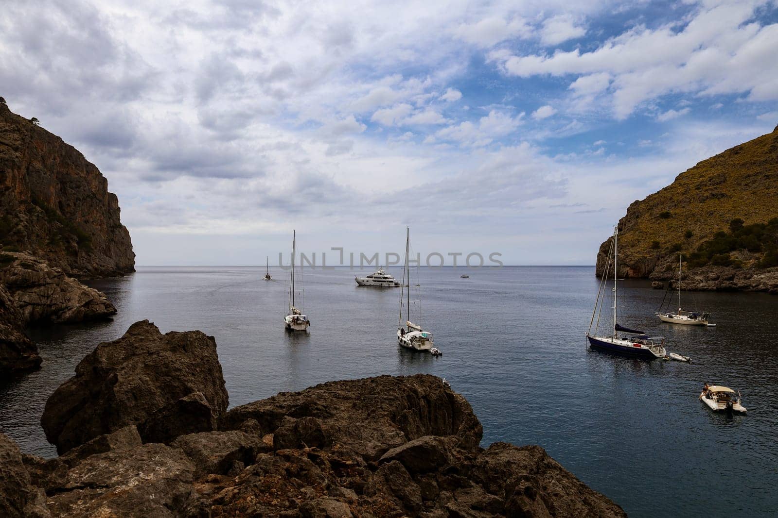 Rocky bay with boats and cloudy Sky. High quality photo