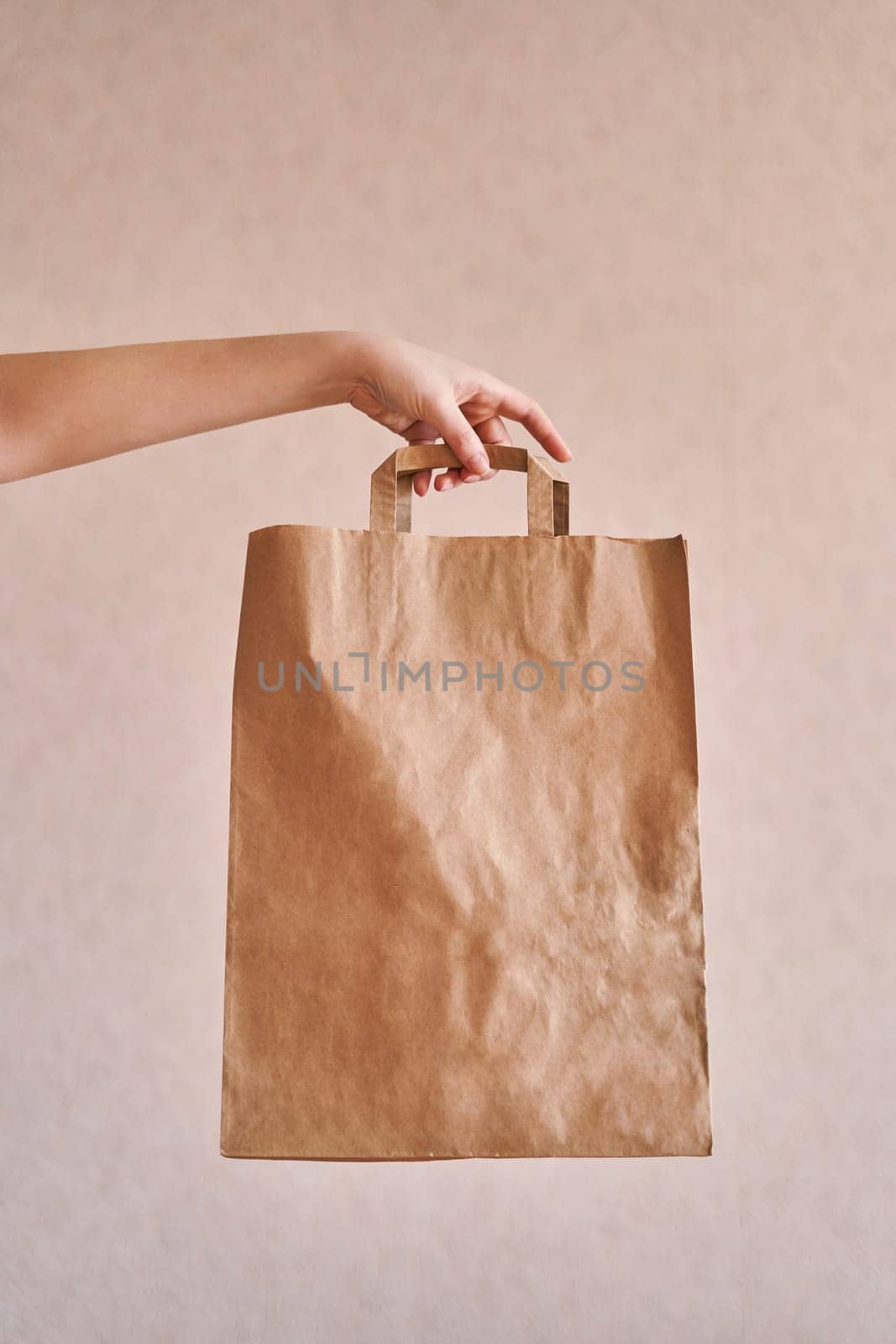 Girl holds an eco-friendly paper bag. Close-up by driver-s
