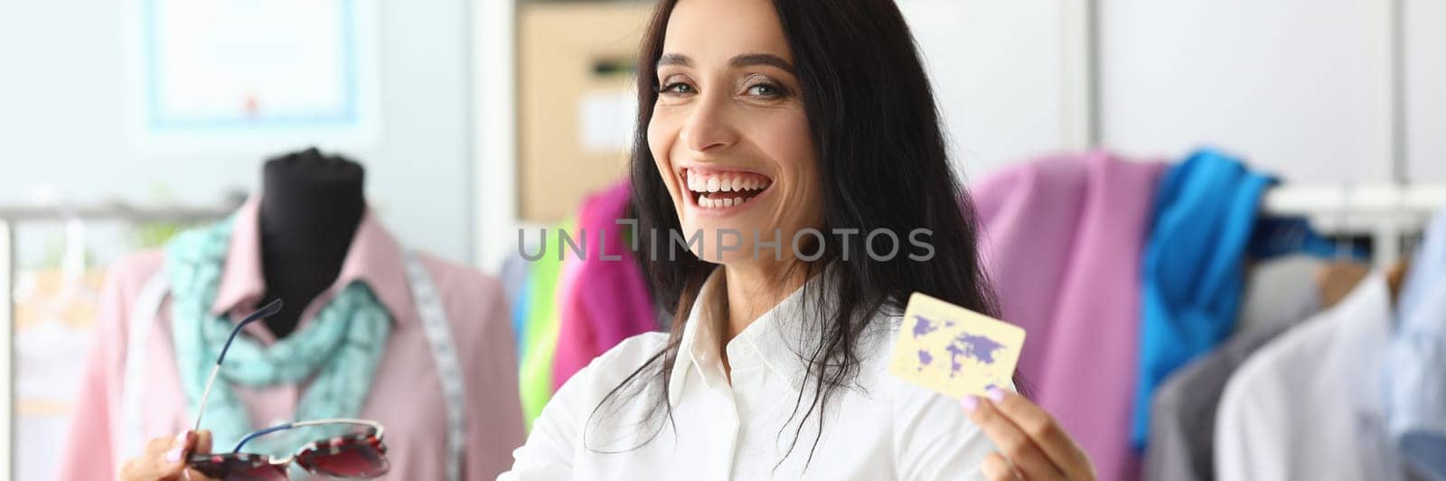 Happy smiling laughing woman holding bank card and purchase packages. Positive emotions shopping concept