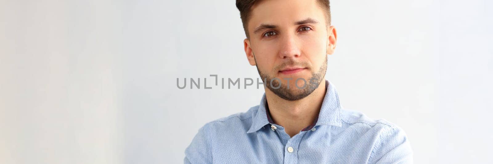 Portrait of handsome young business man posing for camera by kuprevich