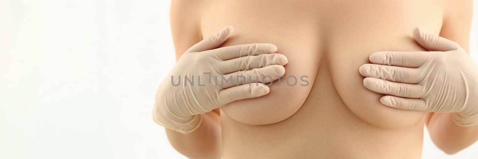 Body of beautiful woman covering large breasts. Plastic surgery and breast augmentation and lift
