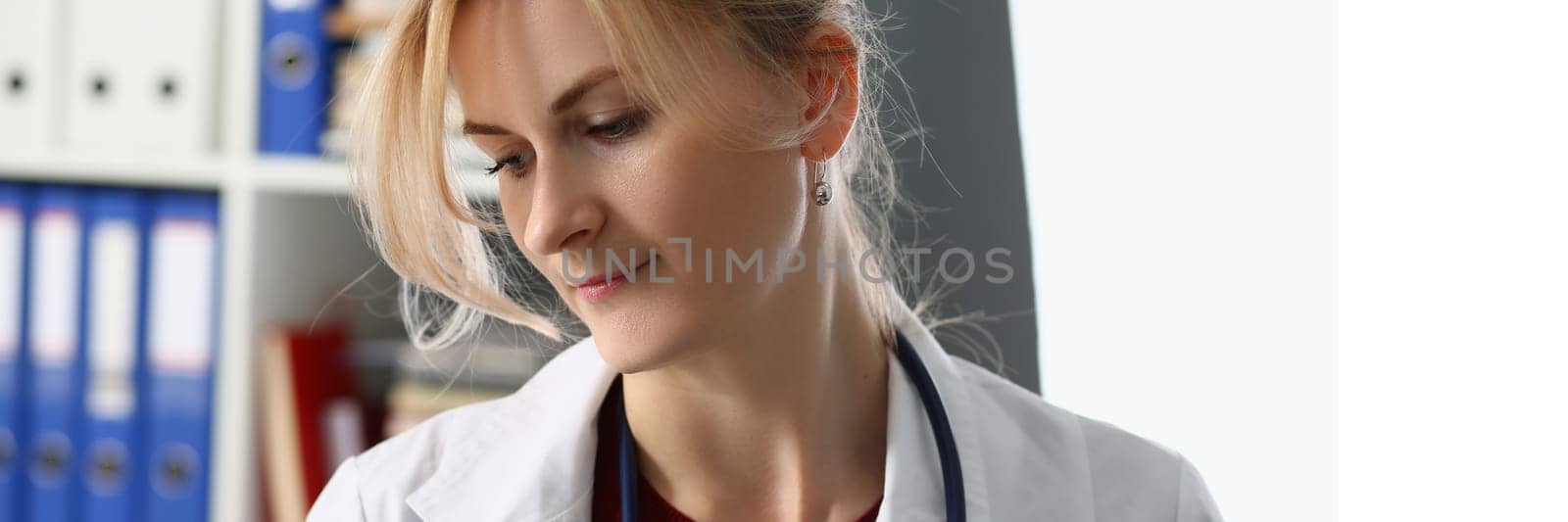 Portrait of sad female doctor in clinic. Doctor surgeon therapist looks tired and bored from depressive problems in clinic