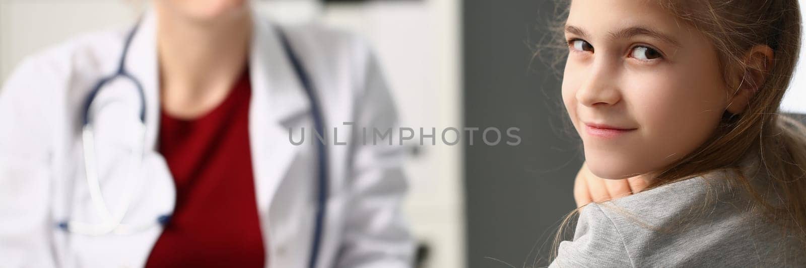 Doctor measures blood pressure of little girl child by kuprevich