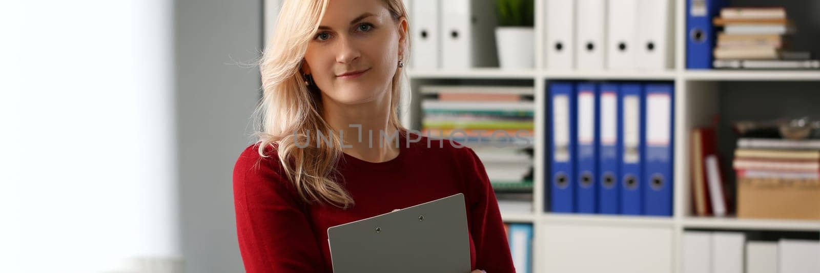 Woman secretary manager is holding documents in office. Businesswoman and assistant consultant concept