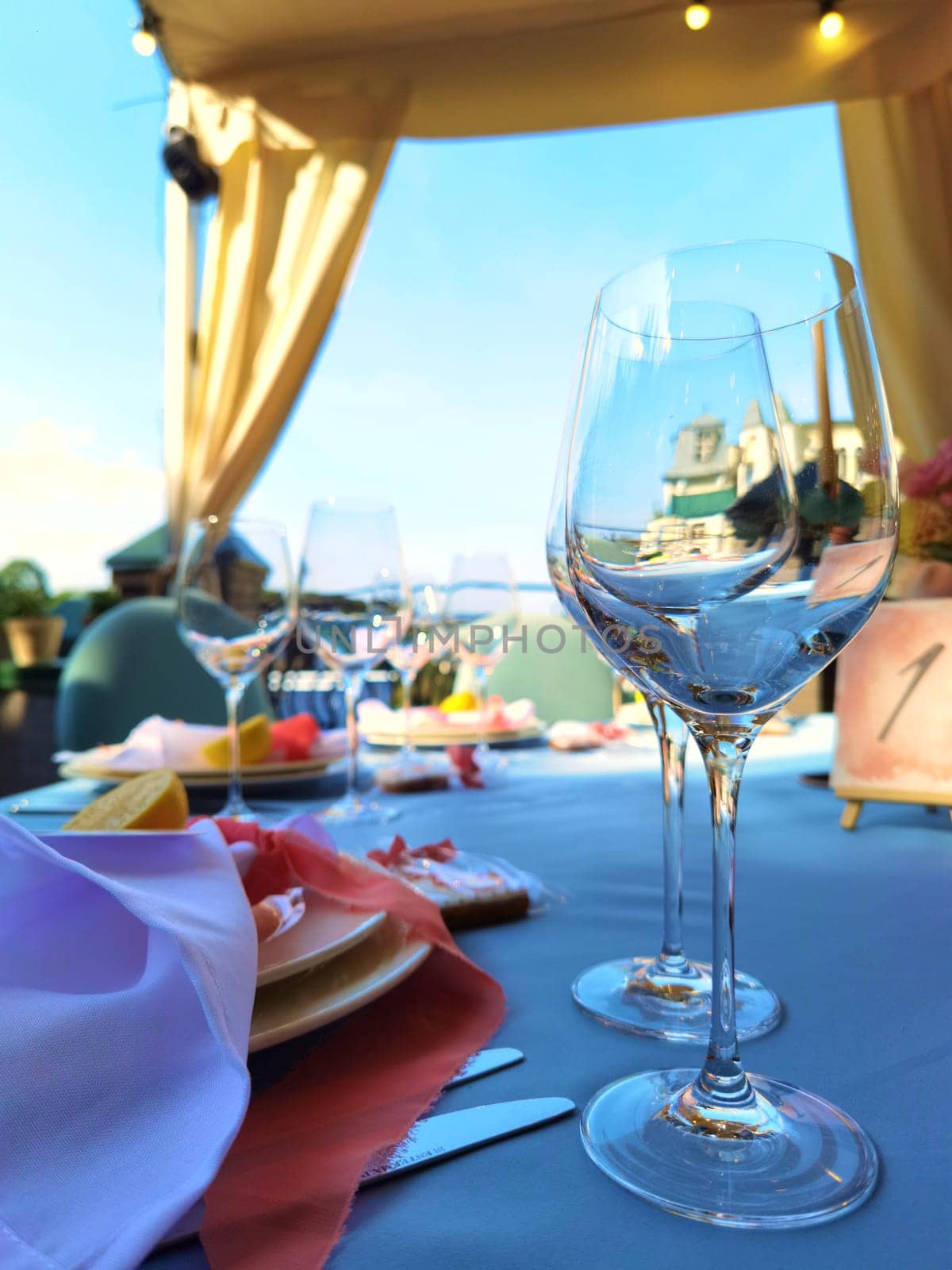 Wine glass on table in restaurant. Shallow DOF. by sarymsakov