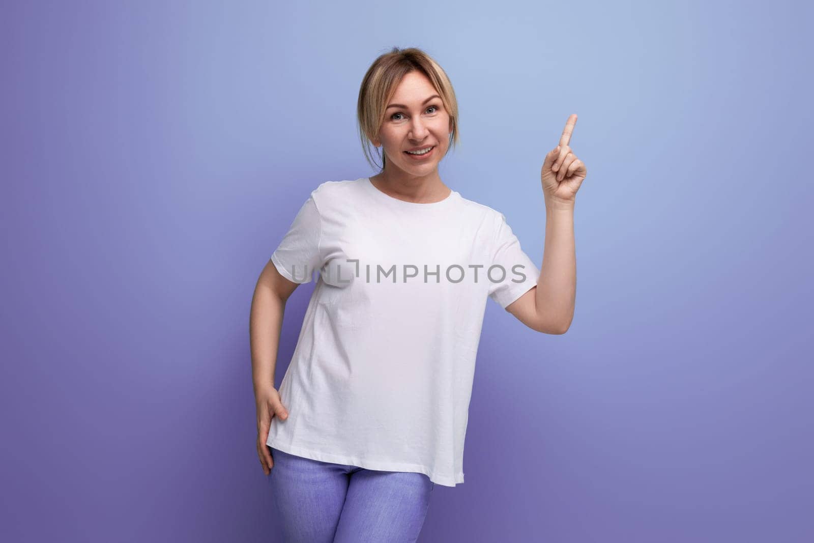 blond young woman in a white T-shirt for thermal printing on a studio background with copy space.
