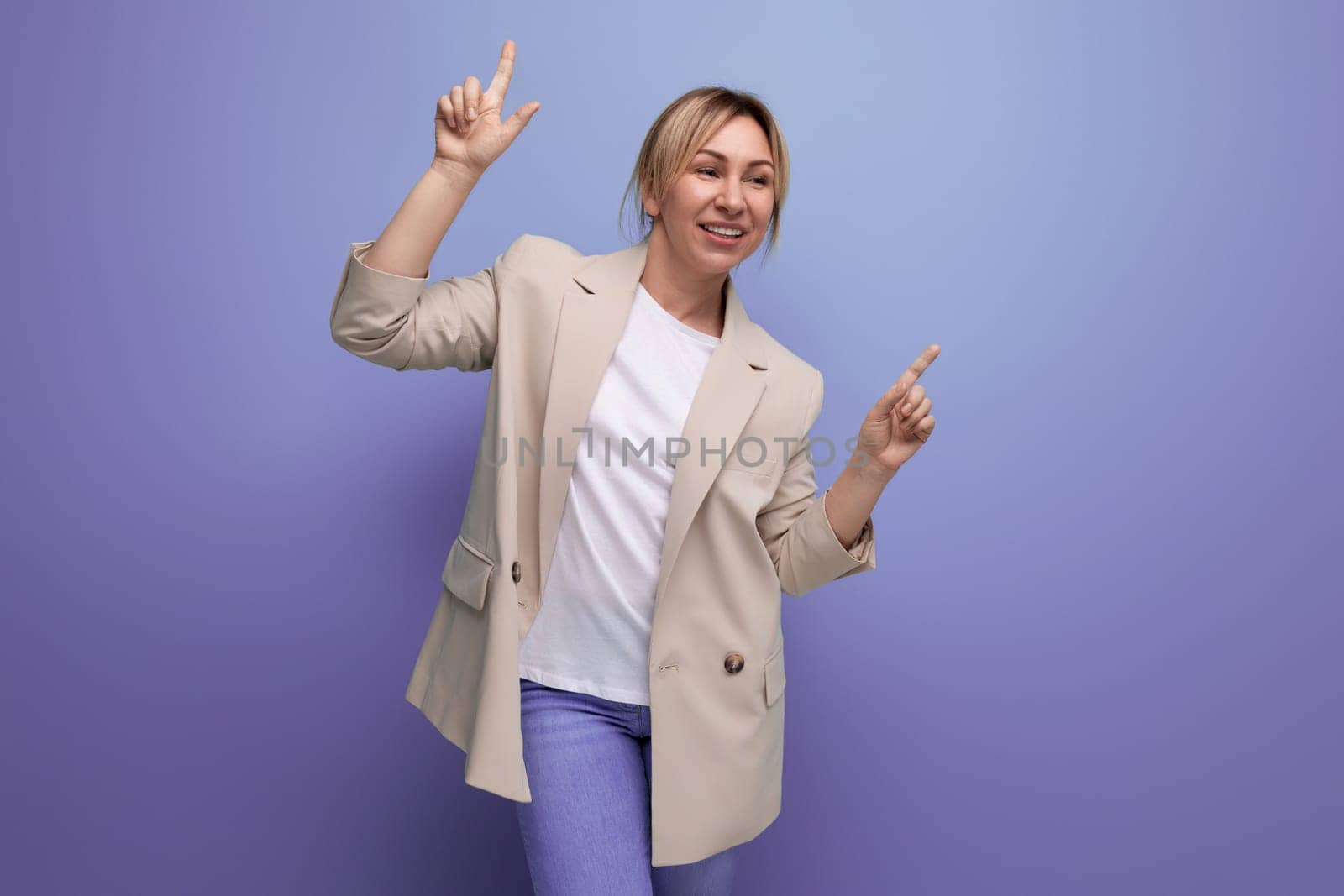 close-up of a positive hopeful blonde business woman in a jacket on the background with copy space by TRMK