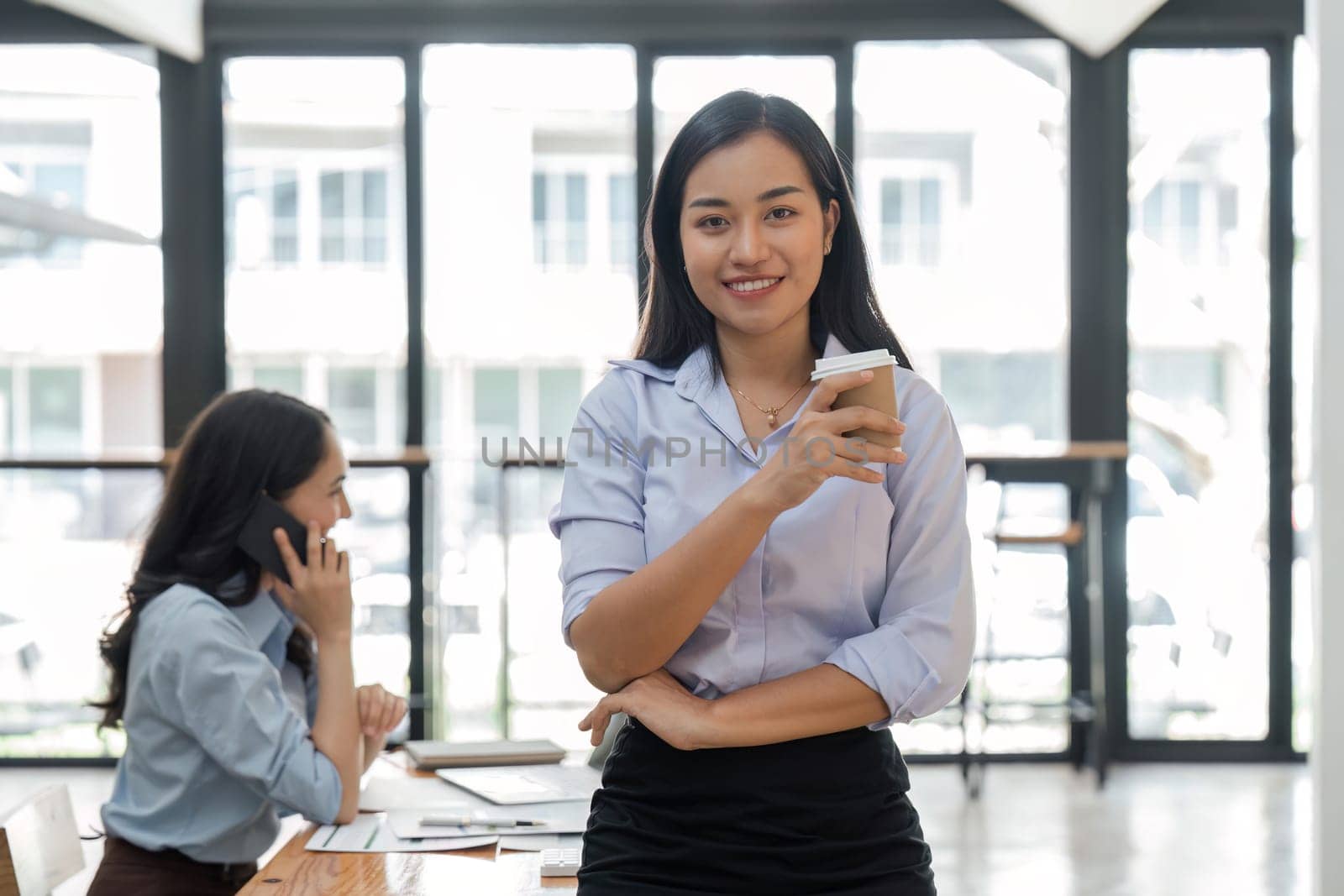 Young asian business woman entrepreneur looking at camera in the office.