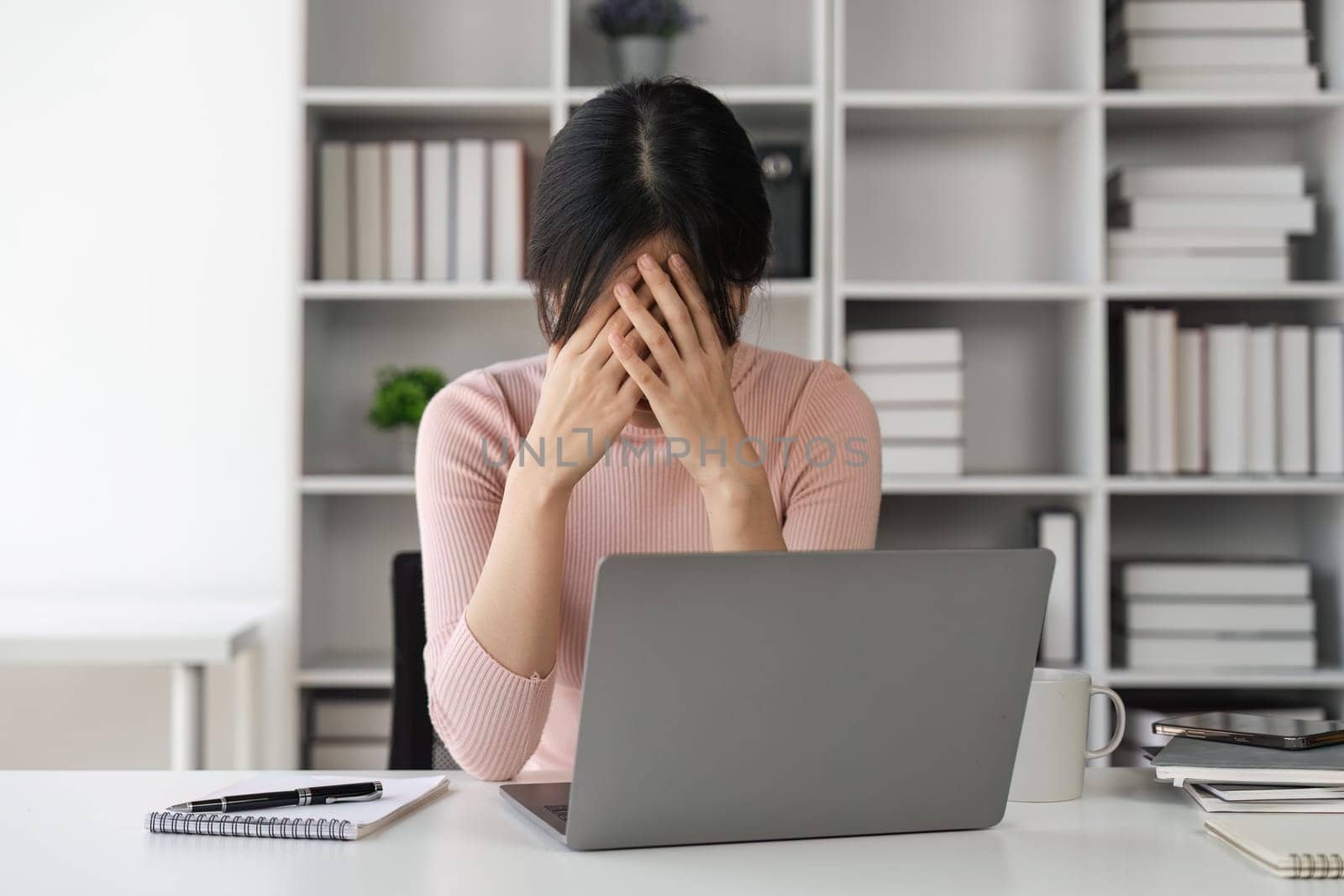 Bored sleepy asian lady sitting at desk with laptop, tired young female feeling drowsy, lazy and unmotivated student, boring job, lack of sleep.