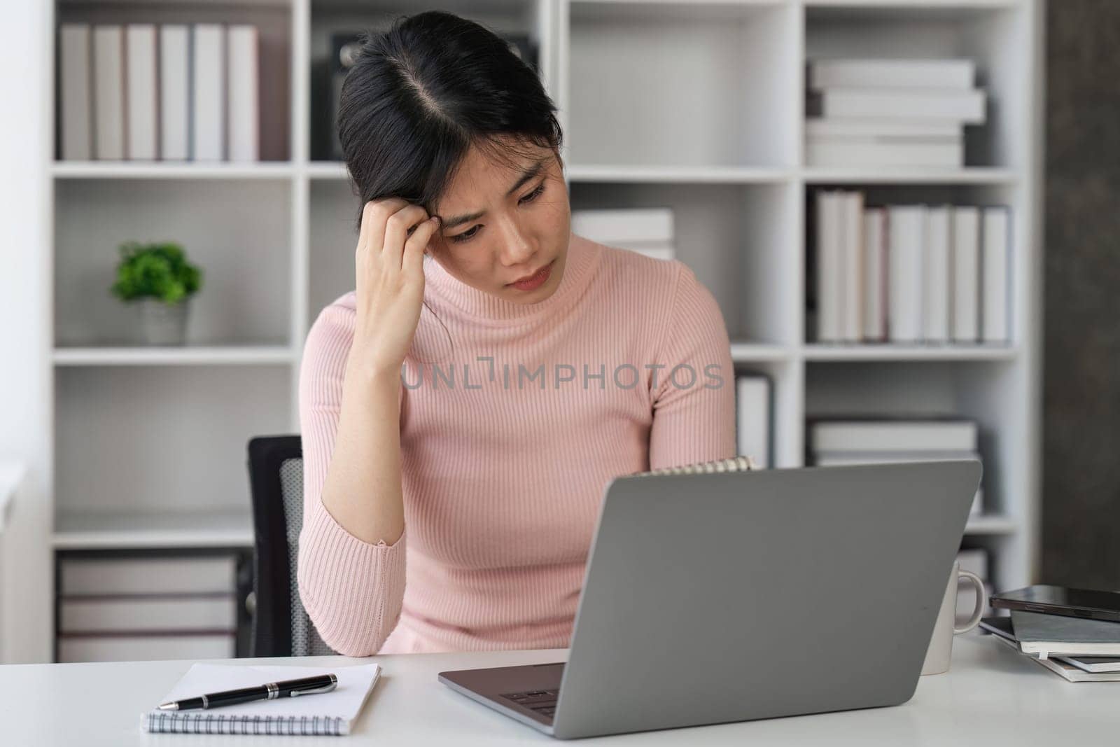 Bored sleepy asian lady sitting at desk with laptop, tired young female feeling drowsy, lazy and unmotivated student, boring job, lack of sleep.