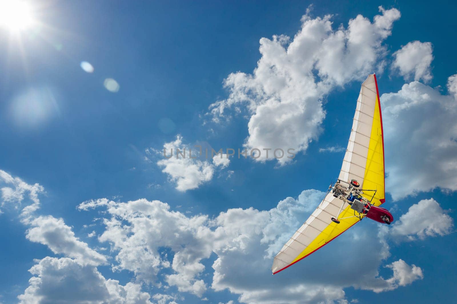 Motoplane with a cradle or motoplane in a clear blue sky.