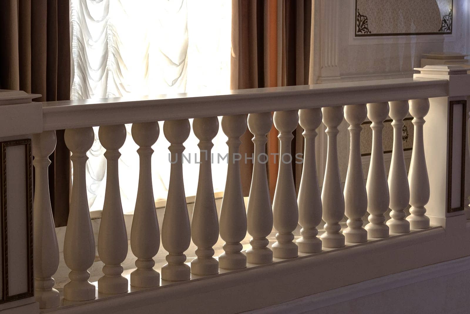 Fences made of stone railings with balusters in a classic interior.