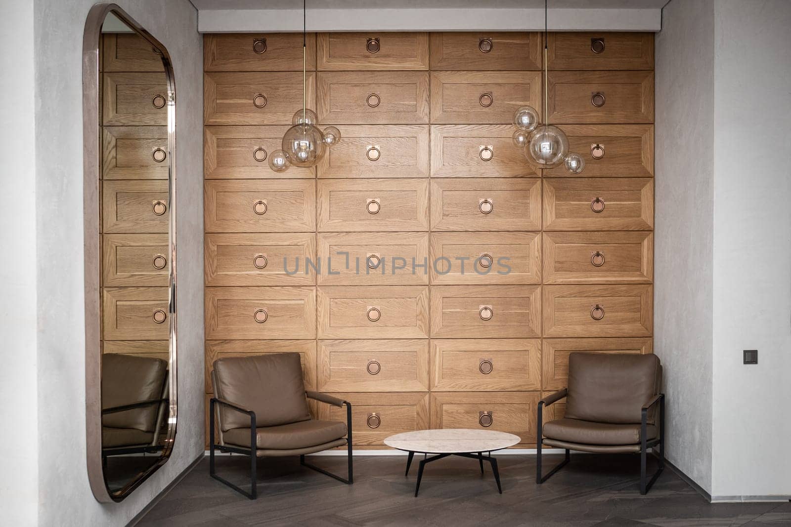 Modern waiting area interior in a mini hotel with a coffee table and two armchairs, hostel lobby interior.