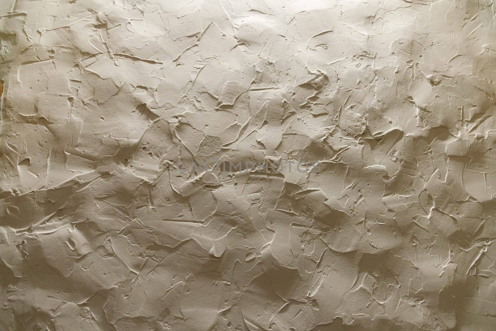 Beige uneven wall made of clay in grunge style. High quality photo