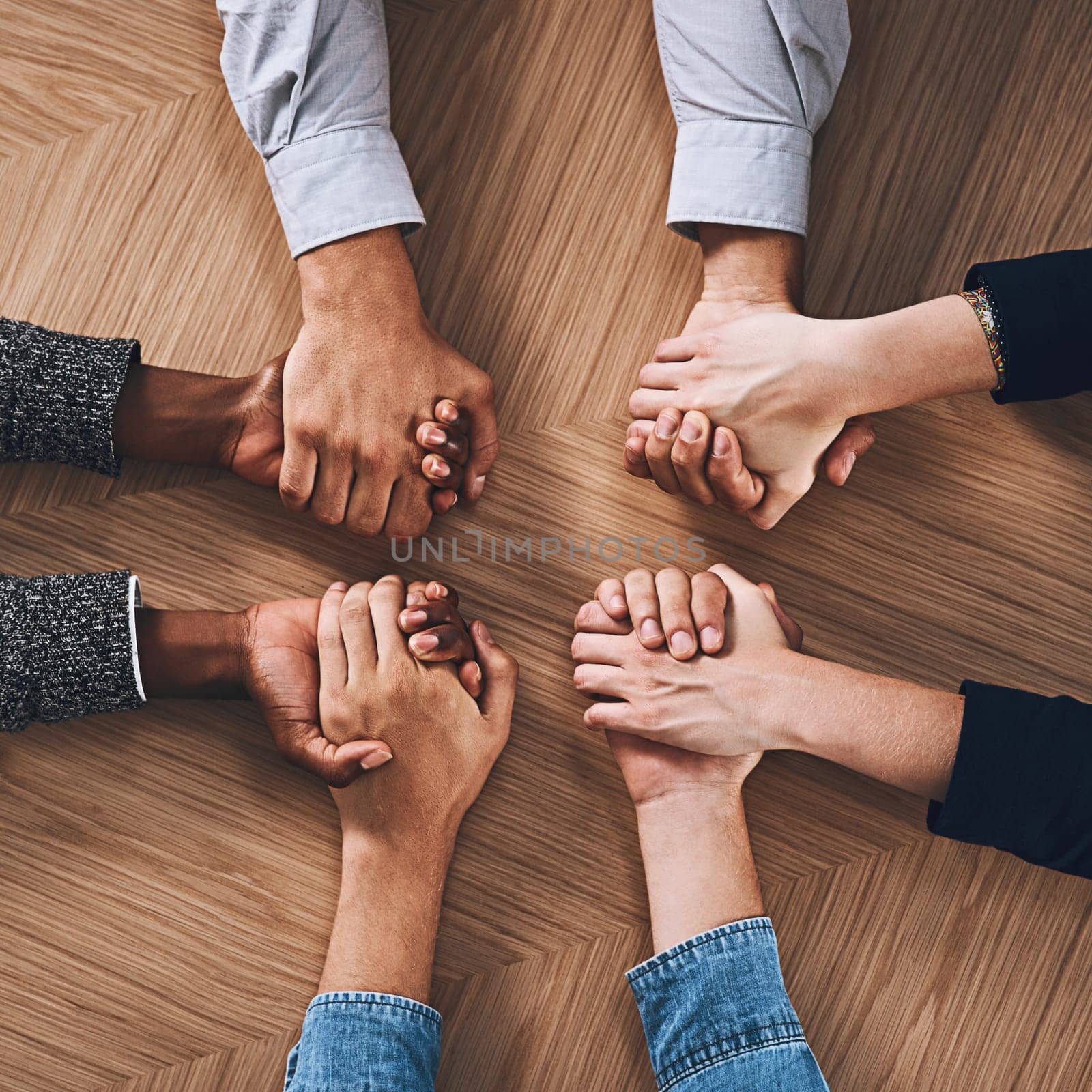 Above, partnership or business people holding hands for support, teamwork or strategy in office. Motivation, zoom or employees in group collaboration with diversity or mission for goals together.