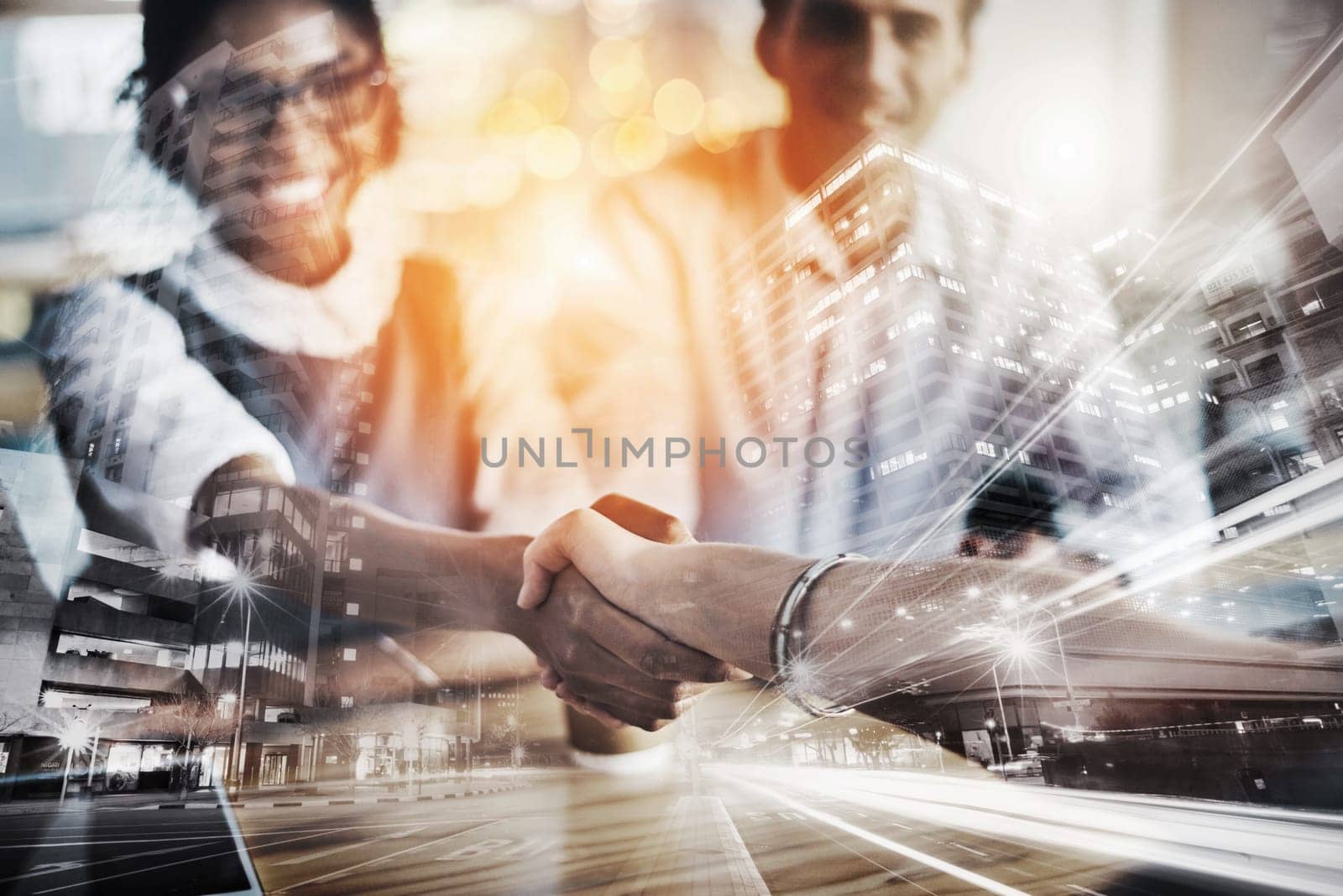 Striking a deal. two young businesspeople shaking hands during a meeting in the boardroom