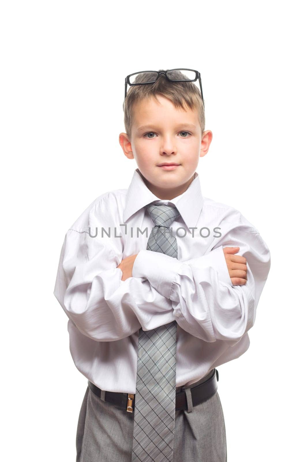Boy in a gray suit and white shirt with glasses on his head on white background by andreyz