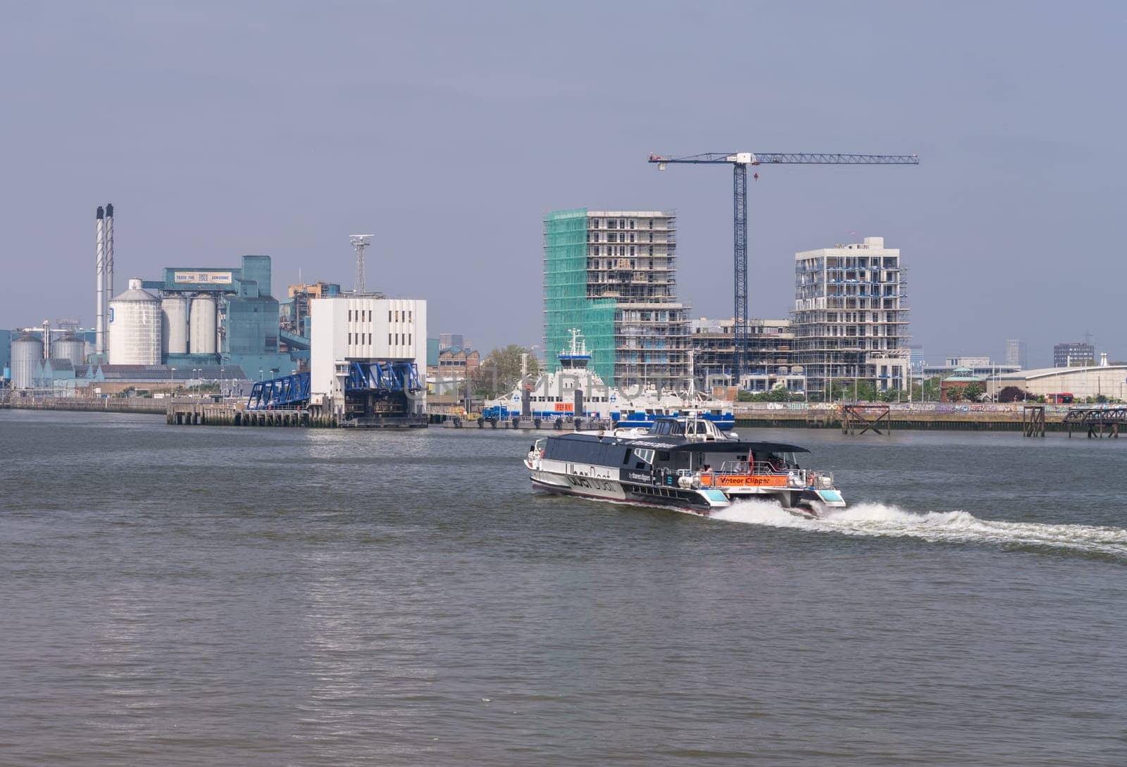 Uber boat speeding past Woolwich Ferry terminal on river Thames by steheap