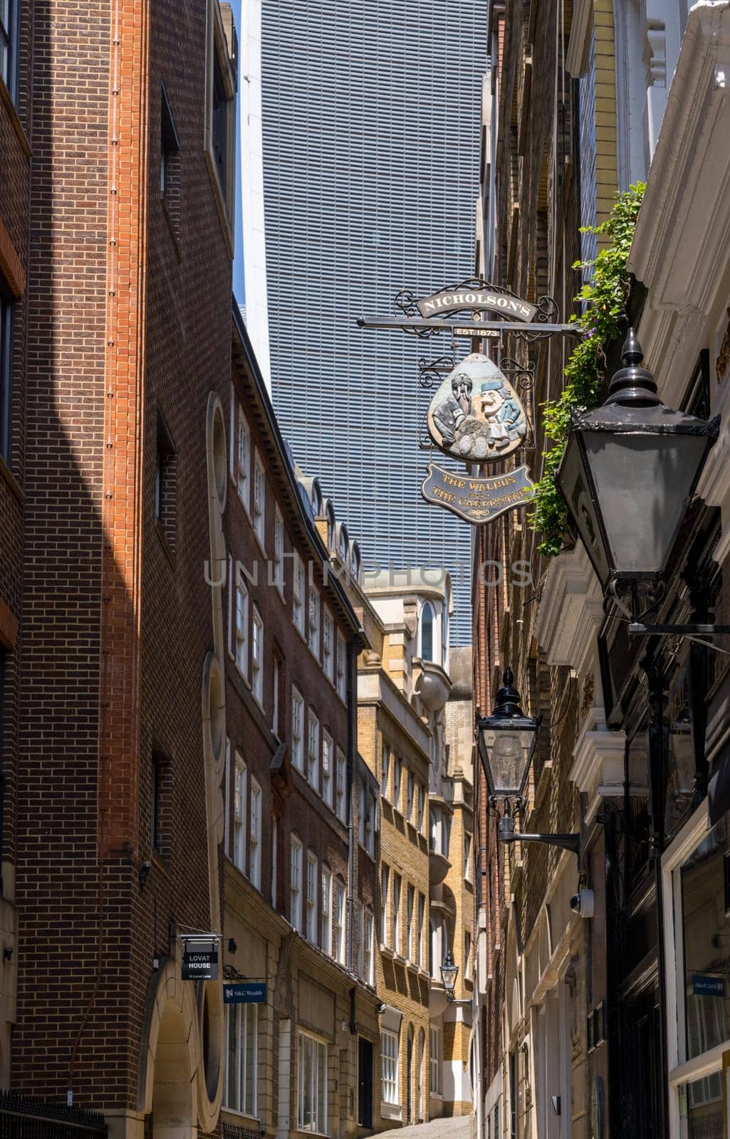 Lovat Lane in the City of London with skyscrapers filling sky by steheap