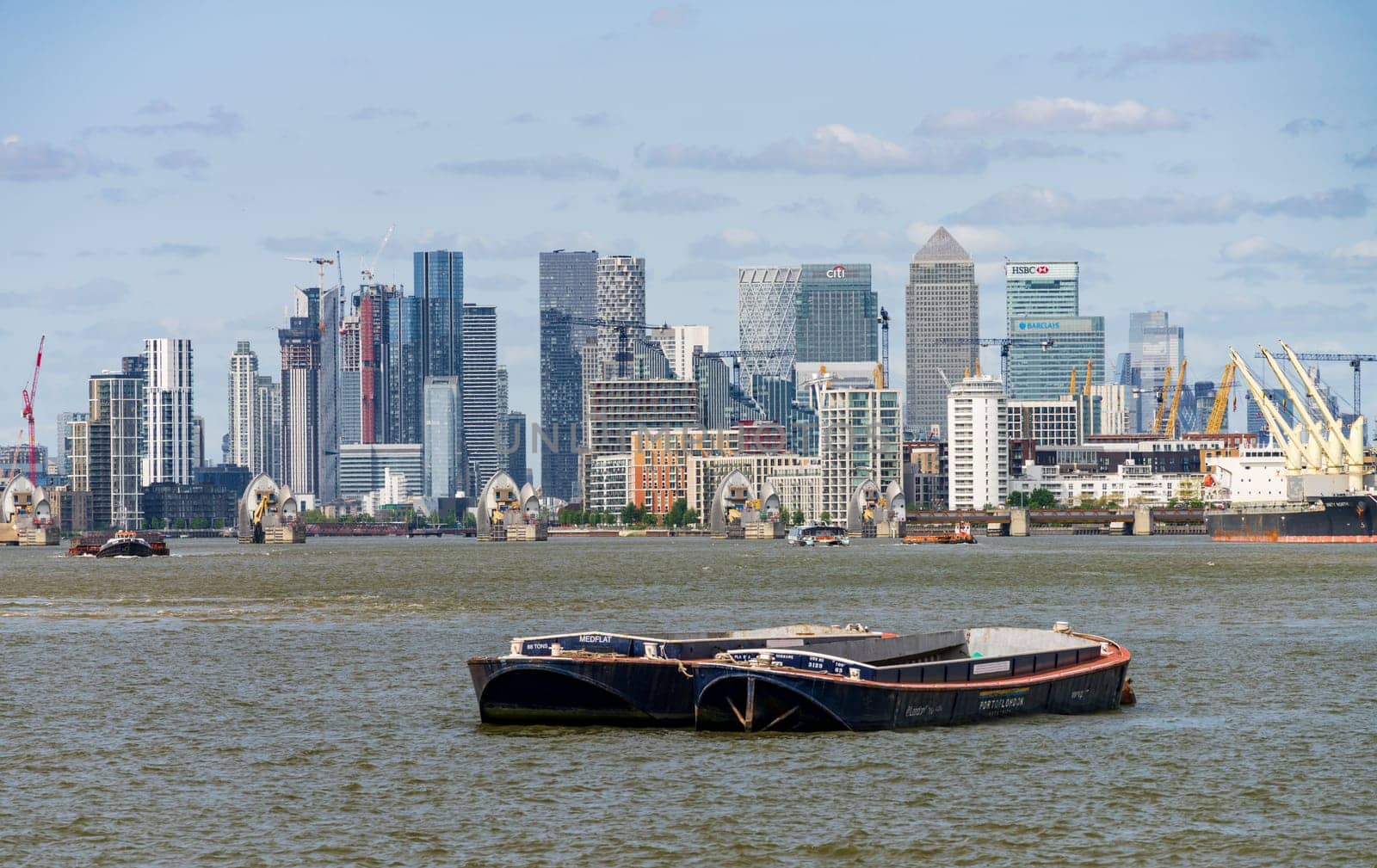 Cityscape of financial district from Woolwich on river Thames by steheap