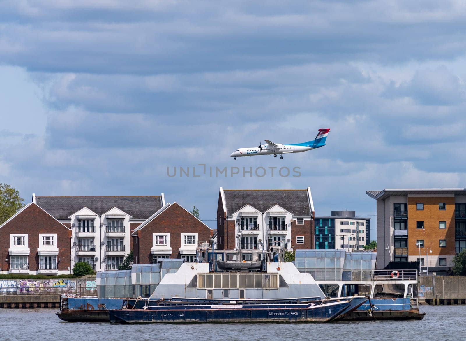 Luxair plane flying low over homes in North Woolwich London by steheap