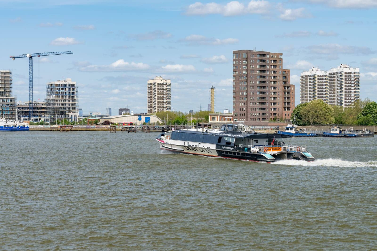 Woolwich, London - 15 May 2023: UberBoat by Thames Clipper speeding towards Woolwich Ferry terminal on Thames
