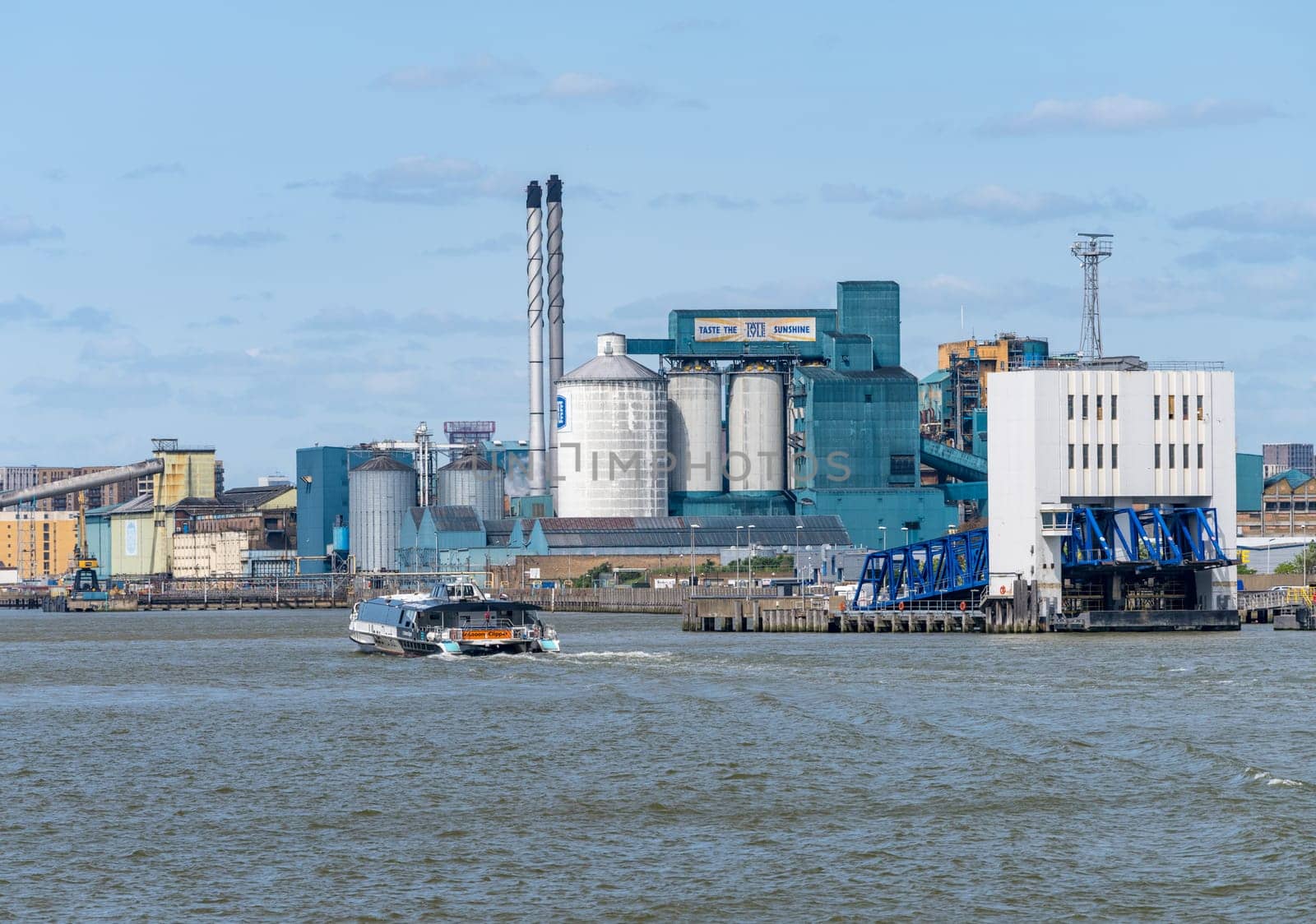 Uber boat speeding past Woolwich Ferry terminal on river Thames by steheap