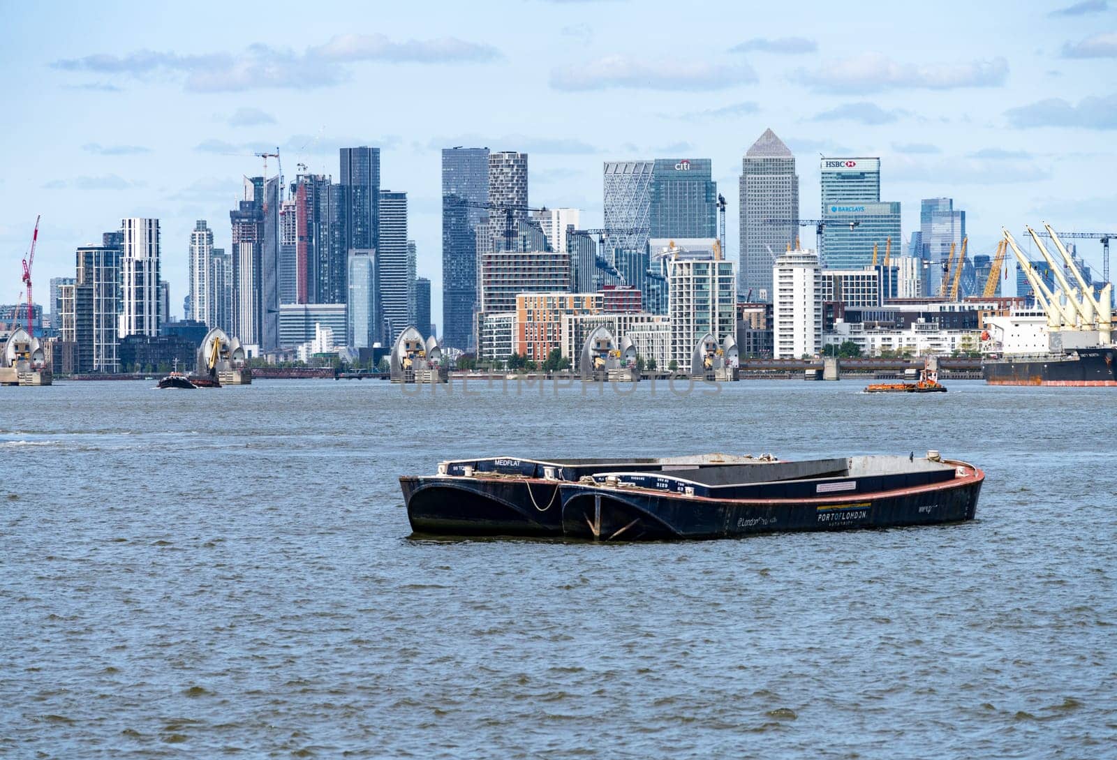 Woolwich, London - 15 May 2023: Skyline of city district of London and Thames Barrier from Woolwich