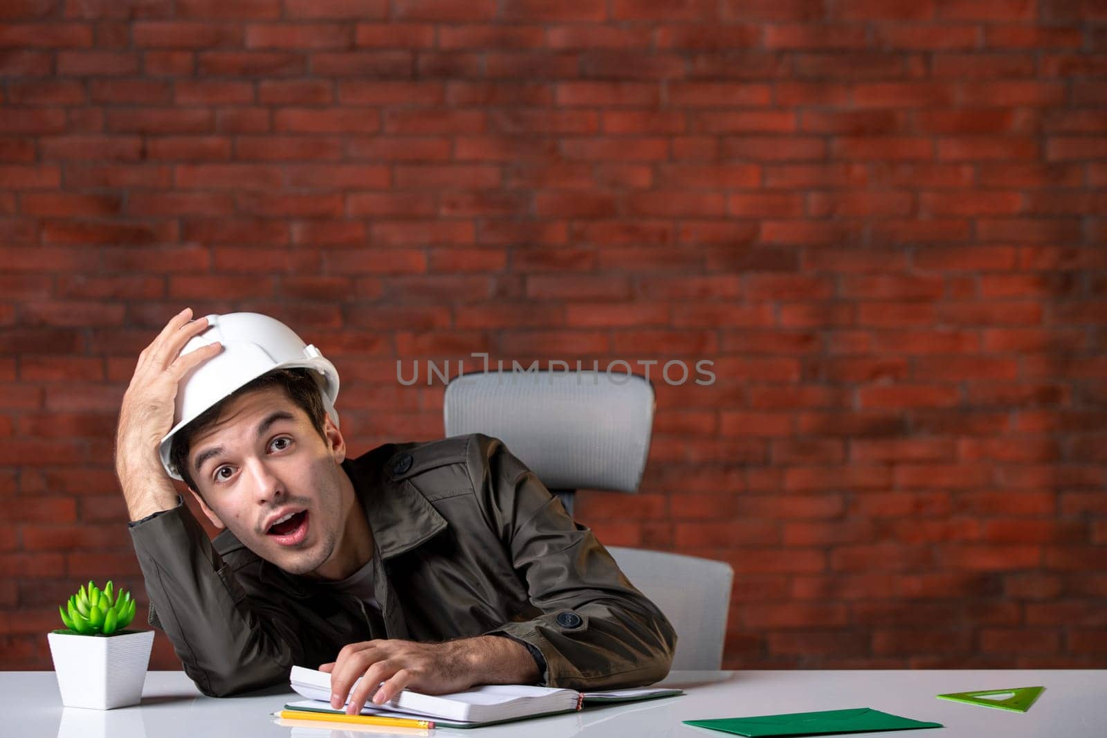 front view male engineer sitting behind his working place and feeling tired plan job business corporate contractor agenda property builder by Kamran